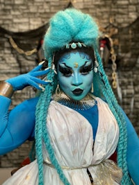 a woman in a blue costume posing for a photo